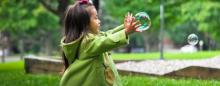 little girl blowing bubbles